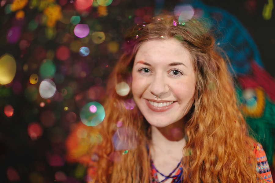 A person surrounded by soft coloured lights